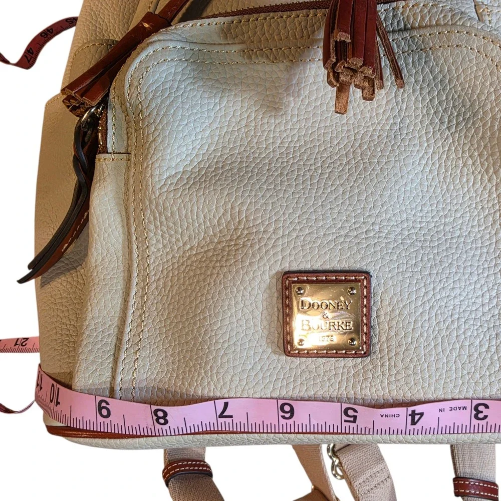 Dooney & Bourke Pebbled Leather Drawstring Backpack White Tan Tassel Logo